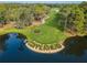 Aerial view of the Copperhead golf course, featuring pristine green lawns and scenic pond at 36750 Us 19 N # 24-211, Palm Harbor, FL 34684