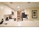 Bright kitchen featuring white cabinets, stainless steel appliances, and a pantry at 36750 Us 19 N # 24-211, Palm Harbor, FL 34684