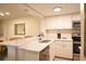 Well-lit kitchen featuring a stainless steel dishwasher, oven, microwave and a breakfast bar at 36750 Us 19 N # 24-211, Palm Harbor, FL 34684