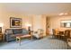 Comfortable living area with a sofa, chair, table, and dining set, with artwork at 36750 Us 19 N # 24-211, Palm Harbor, FL 34684