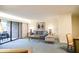 Living room area with a sliding glass door to a private balcony, with a view of the outside at 36750 Us 19 N # 24-211, Palm Harbor, FL 34684