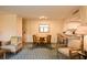 Inviting living space with chairs, dining table, and open access to the kitchen at 36750 Us 19 N # 24-211, Palm Harbor, FL 34684