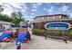 Community pool entrance with Loch Ness sign, covered bicycles and bench on the brick walkway at 36750 Us 19 N # 24-211, Palm Harbor, FL 34684