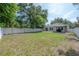 Expansive fenced backyard with a paved patio, gazebo, and lush lawn at 3906 N Lynn Ave, Tampa, FL 33603