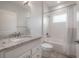 Bright bathroom featuring a granite countertop vanity and a tub with subway tile surround at 3906 N Lynn Ave, Tampa, FL 33603