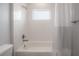 Bathroom features subway tile in shower and tub, shower curtain and a window at 3906 N Lynn Ave, Tampa, FL 33603