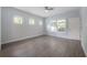 Bright bedroom featuring wood-look flooring, modern ceiling fan, and natural light from multiple windows at 3906 N Lynn Ave, Tampa, FL 33603