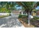 Home with a well-maintained lawn, mature tree, concrete driveway, and a two-car garage at 3906 N Lynn Ave, Tampa, FL 33603