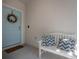 Up-close view of the inviting front door, featuring a wreath and a cozy bench with pillows at 3906 N Lynn Ave, Tampa, FL 33603