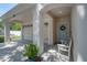 Inviting front porch with seating, covered entry and a view of the garage at 3906 N Lynn Ave, Tampa, FL 33603