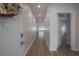 Inviting hallway with hardwood flooring, neutral paint, and an open doorway, leading to an airy living space at 3906 N Lynn Ave, Tampa, FL 33603