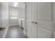 Well-lit laundry room boasts modern machines, wood-look flooring, and ample storage at 3906 N Lynn Ave, Tampa, FL 33603