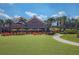 Inviting lawn area furnished with orange Adirondack chairs and sunny yellow umbrellas at 3906 N Lynn Ave, Tampa, FL 33603