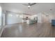 Spacious living room and kitchen featuring hardwood floors and a ceiling fan at 3906 N Lynn Ave, Tampa, FL 33603