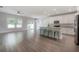 Open-concept living space with modern kitchen, island seating, and sliding glass doors at 3906 N Lynn Ave, Tampa, FL 33603