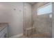 Bright, tiled shower featuring a built-in bench and pebble-stone floor at 3906 N Lynn Ave, Tampa, FL 33603