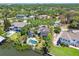 Aerial view of the waterfront home featuring a private pool, lush greenery, and serene water views at 405 S Shore Crest Dr, Tampa, FL 33609
