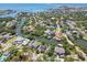 Picturesque aerial view of a waterfront community with lush greenery, swimming pools, and stunning ocean views at 405 S Shore Crest Dr, Tampa, FL 33609