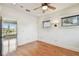 Bright bedroom with hardwood floors, neutral walls, a ceiling fan, and two windows at 405 S Shore Crest Dr, Tampa, FL 33609