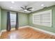 Bright bedroom with hardwood floors, ceiling fan, and a built-in bookshelf at 405 S Shore Crest Dr, Tampa, FL 33609