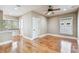 This bedroom features hardwood floors, neutral walls, a ceiling fan, and natural light from windows at 405 S Shore Crest Dr, Tampa, FL 33609