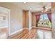 Light-filled bedroom features hardwood floors, neutral walls, and a scenic water view from a large window at 405 S Shore Crest Dr, Tampa, FL 33609