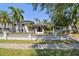 Elegant two-story home with a well-manicured lawn, black metal fence, and beautiful front entrance at 405 S Shore Crest Dr, Tampa, FL 33609