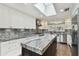 Bright kitchen featuring granite countertops, an island, stainless steel appliances, and a skylight at 405 S Shore Crest Dr, Tampa, FL 33609