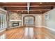 Spacious living room showcasing a stone fireplace, exposed wood beams, and hardwood floors at 405 S Shore Crest Dr, Tampa, FL 33609