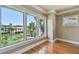 This living room features hardwood floors, white trim, crown molding, and a water view from the windows at 405 S Shore Crest Dr, Tampa, FL 33609