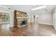 Spacious living room with a stone fireplace, wood flooring, and an abundance of natural light at 405 S Shore Crest Dr, Tampa, FL 33609