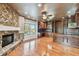 Spacious living room with a stone fireplace, hardwood floors, custom built-ins, and large windows at 405 S Shore Crest Dr, Tampa, FL 33609