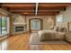 Spacious main bedroom with a stone fireplace, wood-beamed ceiling, and large windows at 405 S Shore Crest Dr, Tampa, FL 33609