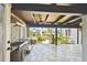 Covered outdoor kitchen featuring a large grill and stone countertops, perfect for outdoor gatherings at 405 S Shore Crest Dr, Tampa, FL 33609