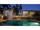 Beautiful backyard pool area with lush landscaping and soft lighting, perfect for evening relaxation at 405 S Shore Crest Dr, Tampa, FL 33609