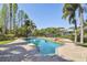 Beautiful swimming pool, surrounded by a brick patio and lush landscaping, with waterfront views at 405 S Shore Crest Dr, Tampa, FL 33609