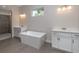 Modern bathroom featuring a soaking tub, separate shower, and double sink vanity with white countertops at 4056 Southern Valley Loop, Brooksville, FL 34601