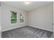 Bright bedroom with large windows offering views of the outdoors and soft carpet flooring at 4056 Southern Valley Loop, Brooksville, FL 34601