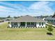 Well-maintained single-story home featuring a symmetrical design and expansive lawn under a bright sky at 4056 Southern Valley Loop, Brooksville, FL 34601