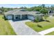 Beautiful single-Gathering home featuring a three car garage, landscaped yard and paver driveway at 4056 Southern Valley Loop, Brooksville, FL 34601