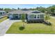 Charming single-story home featuring a landscaped front yard, gray siding, and a brick-paved driveway at 4056 Southern Valley Loop, Brooksville, FL 34601