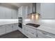 Modern kitchen featuring white cabinets, stainless steel appliances, gas range, and subway tile backsplash at 4056 Southern Valley Loop, Brooksville, FL 34601