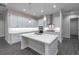 Modern kitchen features white cabinets, an island with a sink, recessed lighting, and stainless steel appliances at 4056 Southern Valley Loop, Brooksville, FL 34601