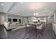 Spacious open-concept living room flowing to a modern kitchen with hardwood floors, modern furniture, and recessed lighting at 4056 Southern Valley Loop, Brooksville, FL 34601