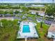 Aerial view of a community pool surrounded by well-maintained lawns and residential buildings at 413 Meadow Ln # 81, Oldsmar, FL 34677