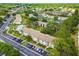 Beautiful aerial view of the condo community featuring lush landscaping, ample parking, and a sparkling community pool at 413 Meadow Ln # 81, Oldsmar, FL 34677