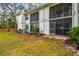 Backyard of a two-story condo with a screened patio, ideal for outdoor dining and relaxation in a private setting at 413 Meadow Ln # 81, Oldsmar, FL 34677