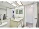 Bright bathroom with ample counter space and a large mirror at 413 Meadow Ln # 81, Oldsmar, FL 34677