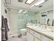Well-lit bathroom with a modern vanity, a frameless glass shower, and decorative fish accents at 413 Meadow Ln # 81, Oldsmar, FL 34677