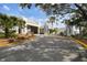 An attractive multi-story building with lush landscaping featuring palm trees and a circular driveway at 413 Meadow Ln # 81, Oldsmar, FL 34677